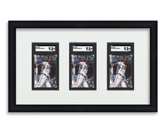 three baseball cards are hanging in a black and white frame with the number 54 on them