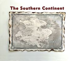 the southern continent map on display in a glass case with red text that reads,'the southern continent '