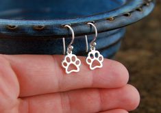 Paw print outline charm earrings in sterling silver, pawprint, cat paw, dog paw, heart charm, cat jewelry, dog jewelry, pets, canine, feline Cute paw print charms are suspended from sterling silver ear wires. The paw print outline charm measures 0.60 x 0.39 inches (15 x 10mm) and the earrings measure 0.91 inches (23mm) in length. Perfect with any outfit! Your purchase will arrive in a jewelry box ready for gift giving or as a gift for yourself! Enter my shop here: jersey608jewelry.etsy.com Thank Paw Print Outline, Fashion Earrings Studs, Paw Jewelry, Paw Print Earrings, Paw Print Jewelry, Paw Heart, Paw Print Charm, Dog Earrings, Dog Jewelry