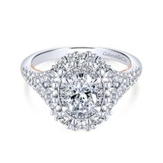 a diamond engagement ring with an intricate halo setting