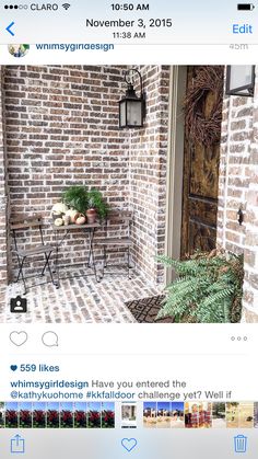 an image of a brick wall with potted plants on the front and back porch