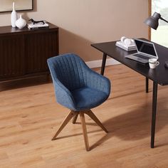 a blue chair sitting in front of a desk with a laptop computer on top of it