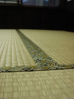 a close up view of a bed with a tape on it's bottom edge