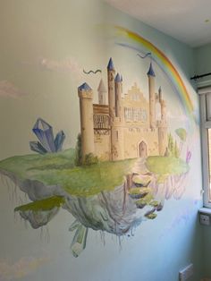 a mural on the wall of a child's room with a castle painted on it