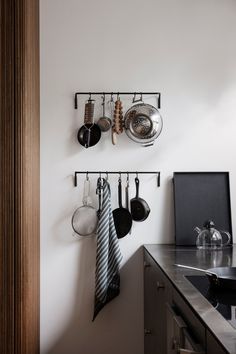 pots and pans are hanging on the wall