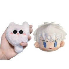 two stuffed animals in the palm of someone's hand, one with an eye patch