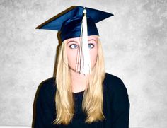 a woman wearing a graduation cap and gown is making a face with her eyes wide open