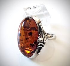 Large Oval Amber Classic Ring in Silver Frame BuyRussianGifts Store Classic Amber Oval Cabochon Ring, Oval Baltic Amber Rings In Amber Color, Oval Baltic Amber Ring In Amber, Oval Baltic Amber Ring, Cognac Color, Amber Ring, Amber Jewelry, Amber Color, Classic Ring