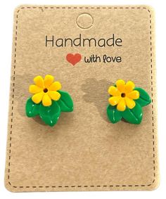 pair of yellow and green flower stud earrings on cardboard card with i love handmade