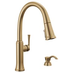 the kitchen faucet is shown in brushed brass, and features a pull - down spout