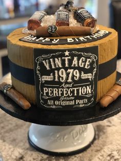 a cake made to look like an old barrel with cigars and bottles on top