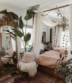 a bed room with a large mirror and plants