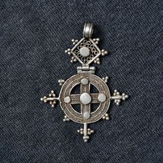 A stunning piece of Ethiopian Coptic Christian pendant handmade with a silver coins melted and casted as cross by local silversmith.  Suitable for all occasions and is uniquely eye catching statement piece. Perfect addition to any ethnic, regional or religious jewelry collection.  :: Measurement :: 1:- 60 x 50 mm 2:- 80 x 45 mm 3:- 65 x 50 mm 4:- 90 x 55 mm Silver Cross Necklace With Coin Pendant, Traditional Engraved Crucifix Jewelry, Traditional Cross Pendant Necklace With Intricate Design, Traditional Cross Jewelry With Intricate Design, Traditional Necklace With Intricate Cross Pendant, Byzantine Cross Sterling Silver Jewelry, Silver Byzantine Cross Jewelry, Silver Byzantine Medallion Necklace, Byzantine Sterling Silver Cross Jewelry