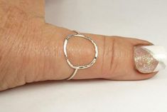 A hammered circle ring made with 18 gauge wire. Modern and simple minimal jewelry.Made with sterling silver Handmade and polished to a high shine in my shop.The circle symbol meaning is universal, sacred and divine. It represents the infinite nature of energy, and the inclusivity of the universe.Purity ring, karma ring,  midi ring modern and simplesize 4-13 1/2  if you need a different size just put that in notes to seller or convo me.sterling silver ring Silver Hammered Minimalist Midi Rings, Hammered Sterling Silver Midi Rings, Minimalist Hammered Sterling Silver Midi Rings, Simple Hammered Rings, Handmade Simple Sterling Silver Midi Rings, Silver Hammered Midi Rings, Simple Silver Round Midi Rings, Hand Forged Sterling Silver Stackable Rings, Karma Ring