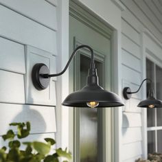 two outdoor lights on the side of a house