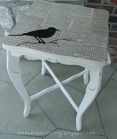 a small table with a bird painted on it