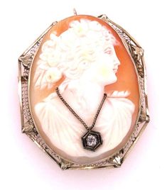 For Sale on 1stDibs - 14 Karat White Gold Cameo Brooch and Pendant Woman Profile With Diamond Necklace 11.8 grams total weight. Height: 50 mm Width: 35 mm Luxury Formal Necklace With Brooch, Victorian White Gold Pendant Brooches, Ornate Pendant Brooch For Formal Occasions, Fine Jewelry Necklaces With Brooch For Anniversary, Elegant Formal Brooch With Intaglio Detail, White Oval Brooch Jewelry, Oval Brooch In Fine Jewelry Style For Formal Occasions, Elegant Medallion Brooch For Formal Occasions, Elegant Intaglio Brooch For Formal Occasions