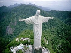 the statue of christ stands high above the city and surrounding mountains in rio cristo, brazil