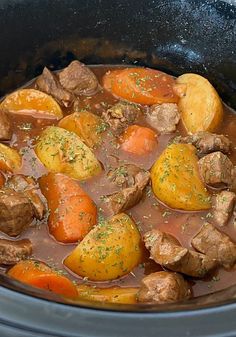 beef stew with carrots and potatoes in a crock pot ready to be eaten