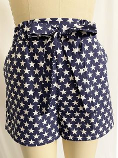 This is a pair of high-rise woven shorts featuring patriotic stars on blue pattern. Stretchy waistband with front self-tie and slanted front pocket. Woman Shorts, Hatch Pattern, Patriotic Stars, Photo Mask, Love Blue, Blue Pattern, Fourth Of July, Short Outfits, Front Pocket