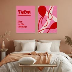 two paintings on the wall above a bed in a room with pink walls and pillows