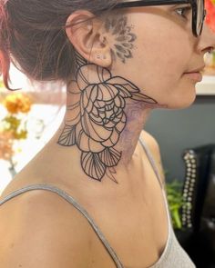 a woman with a tattoo on her neck