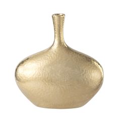 a gold vase sitting on top of a white surface