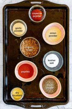 spices in small glass bowls on a baking sheet with the words seasoning powders