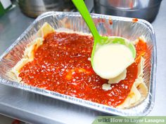 a plastic container filled with sauce on top of a stove