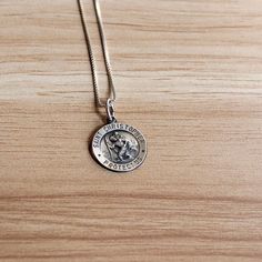 This vintage sterling silver Saint Christopher necklace is a piece worn for protection.  Sterling silver is hypoallergenic and safe for those with sensitive skin. DIMENSIONS:  Chain length: 22.0 inches  Pendant dimensions: 15.2 millimeters x 15.2 millimeters Weight: 3.7 grams MAKER'S INFORMATION:  Maker's mark: Q.G.I. Made in: Italy  Please note that vintage jewelry is pre-loved and might have minor imperfections as seen in the listing images. Vintage Sterling Silver Charm Necklaces For Anniversary, Classic Sterling Silver Charm Necklace, Tarnish Resistant, Classic Sterling Silver Charm Necklaces Tarnish Resistant, Sterling Silver Tarnish-resistant Medallion Necklace, Spiritual Sterling Silver Charm Necklace In Silver, Vintage Silver Charm Necklace For Anniversary, Silver Vintage Charm Necklace For Anniversary, Spiritual Sterling Silver Charm Necklaces In Silver, Silver Engraved Round Charm Necklaces