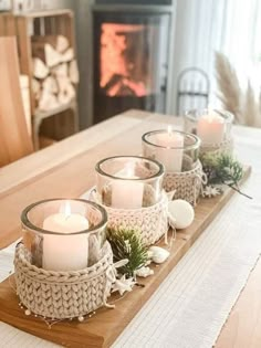 some candles are sitting on a wooden tray