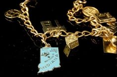 This is a very beautiful, very unique and vintage GF STERLING LINK  charms bracelet. The bracelet has marvelous 9 charms with zodiac, happy birthday, Indiana state, I AM LOVED, locked, college cap, sky girl and gilt starling, gold filled. The bracelet has a very exotic and elegant feel to it. It measures 7" long. The bracelet is in very good condition. 0.7 MR Vintage Charm Bracelet Zales, Gold Charm Bracelet As A Souvenir, Symbolic Vintage Charm Bracelet For Gift, Heirloom Charms Jewelry For Collectors, Antique Charm Bracelet As Gift, Antique Good Luck Charms Jewelry, Antique Souvenir Jewelry With Charms, Heirloom Nickel-free Jewelry For Collectibles, Heirloom Nickel-free Collectible Jewelry