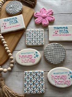 decorated cookies are arranged on a table with beads and tassels next to them