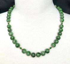 Every woman should have a strand of pearls, but not every woman (or man) has the opportunity to own a strand of rare, chrome diopside beads! This beautiful strand of 10 mm round, variegated chrome diopside beads displays gorgeous shades of basil, sage, and forest greens that makes us appreciate the beauty of nature and the outdoors. Accented with 18k yellow gold, vibrant emerald-green chrome diopside spacer beads, and finished with a high-polished 14k yellow gold clasp. A perfect accompaniment t