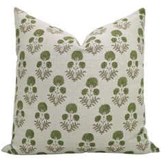 a white pillow with green flowers on it