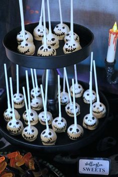 there are some cake pops that have been placed on the tray with candles in them