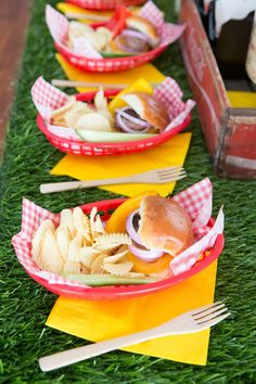 three baskets filled with food sitting on top of green grass