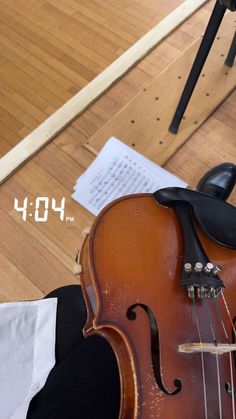 a violin sitting on top of a wooden floor