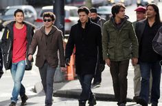 several young men walking down the street together