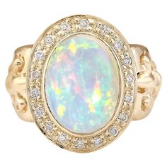 6.40 Carat Natural Opal 14 Karat Yellow Gold Diamond Ring Stamped: 14K Yellow Gold Total Ring Weight: 11.0 Grams Total Natural Opal Weight is 5.90 Carat (Measures: 14.00x10.00 mm) Color: Multicolor Total Natural Diamond Weight is 0.50 Carat Color: F-G, Clarity: VS2-SI1 Face Measures: 20.80x16.65 mm Sku: [704055W] Opal Diamond Ring, Yellow Gold Diamond Ring, Gold Diamond Ring, Natural Opal, Gold Diamond Rings, Opal Rings, Cocktail Rings, Natural Diamonds, Floral Rings