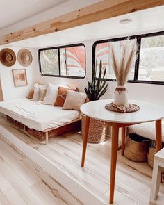 a living room filled with lots of furniture and decor on top of wooden flooring