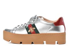 Gucci Women's Ace Silver Embroidered Platform Sneaker N5386 Size 39.5 / 9.5 US Details The classic Ace sneaker is set on a platform and shows the metallic gold bee against the Gucci Web. Since its debut, the Ace sneaker has become a mainstay of Gucci collections.  The retro design is originally inspired by a Gucci sneaker from the 1970s and is continually reinterpreted and reintroduced into the new eclectic House narrative.  Crafted from silver-tone leather with green and red Web and gold thread-embroidered bee; Green metallic leather detail on the back of one shoe and red metallic leather detail on the back of the other shoe; Rubber sole; 45mm platform height;  Made in Italy. Comes with original box 555 Gucci Sneaker, Embroidered Bee, Red Web, Eclectic House, Gucci Women, Gucci Sneakers, Gold Bee, Leather Detail, Gold Thread