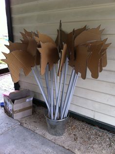 cardboard leaves are placed in a bucket on the ground