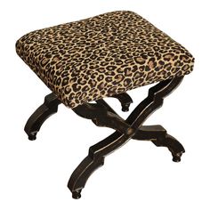 a leopard print foot stool with black legs