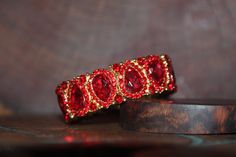 "Beautiful bracelet with red rhinestone crystals, great statement piece! Pageant, prom, or bridal! Size: .75\" wide Style: stretch bracelet color: red crystals Base Metal color: gold Looking for matching earrings or necklace? Browse through our listings or send us a message! :) https://www.etsy.com/listing/551764936/red-rhinestone-necklace-and-earrings-set?ref=shop_home_active_15 https://www.etsy.com/listing/550716625/red-and-ab-rhinestone-earrings-red-large?ref=shop_home_active_50 Looking for t Prom Bracelet, Hot Pink Bracelets, Valentines Bracelets, Blue Crystal Necklace, Red Bracelet, Gold Bridal Earrings, Prom Earrings, Red Prom, Red Bracelets