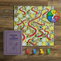 a board game with numbers and ladders next to it