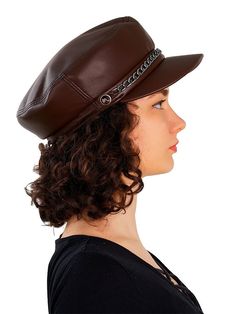 a woman with curly hair wearing a brown hat