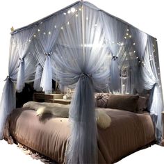 the canopy bed is decorated with fairy lights and draping on it's sides