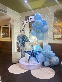 balloons, starfish and seashells are on display in the lobby