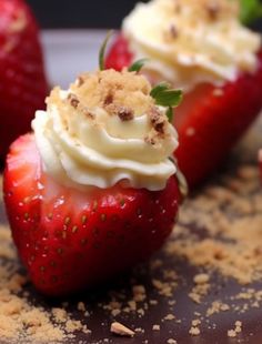 three strawberries with whipped cream and chocolate shavings